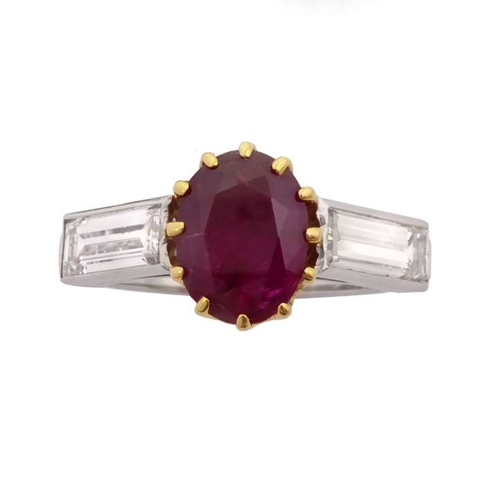 Single stone oval ruby and baguette diamond ring